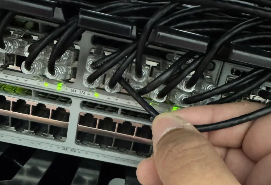 A network cable being seated into a switch during a small business setup.