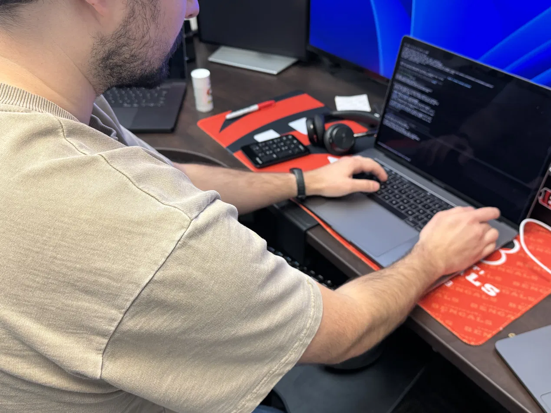 A Deskside technician working at a desk, connected to a customer machine during a scheduled remote session.